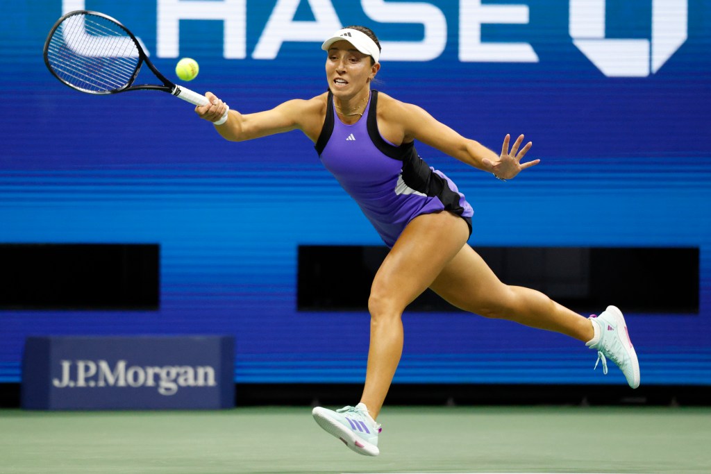 Jessica Pegula of the US returns serve to Iga Swiatek of Poland during their match on Arthur Ashe Stadium.