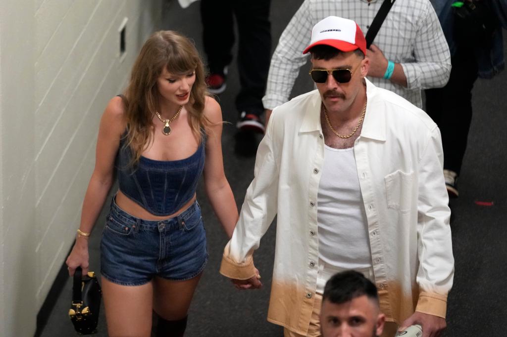 Kansas City Chiefs tight end Travis Kelce, right, and Taylor Swift hold hands following an NFL football game between the Chiefs and the Baltimore Ravens Thursday, Sept. 5, 2024, in Kansas City, Mo.