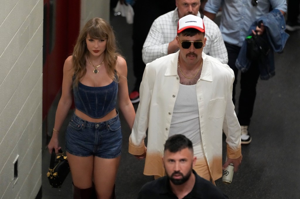 Kansas City Chiefs tight end Travis Kelce, right, and Taylor Swift hold hands following an NFL football game between the Chiefs and the Baltimore Ravens Thursday, Sept. 5, 2024, in Kansas City, Mo.