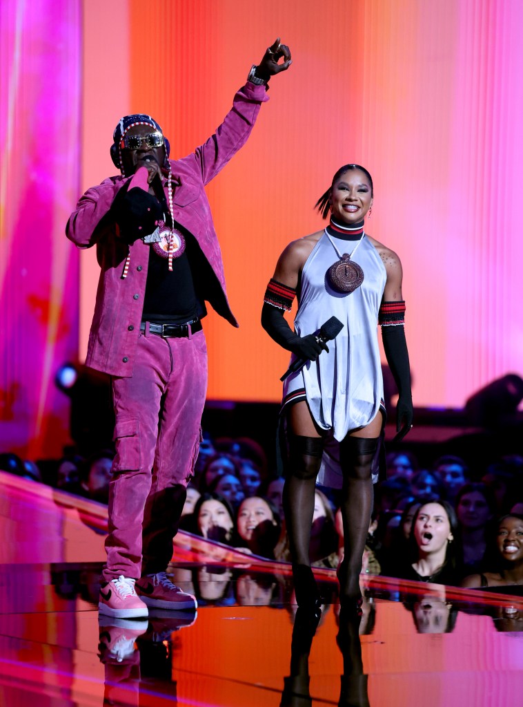 Flavor Flav and Jordan Chiles speak on stage during the 2024 MTV Video Music Awards.