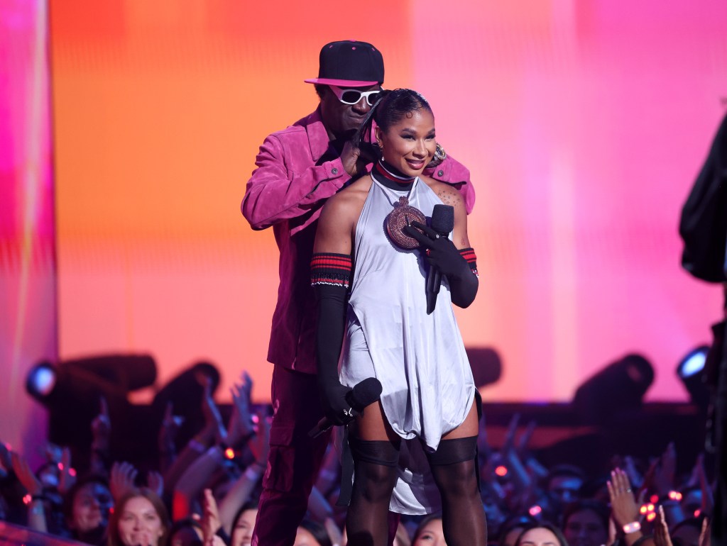 Flavor Flav and Jordan Chiles speak on stage during the 2024 MTV Video Music Awards.