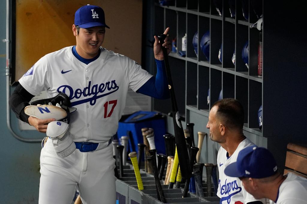 Dodgers designated hitter Shohei Ohtani puts his bat in the racks