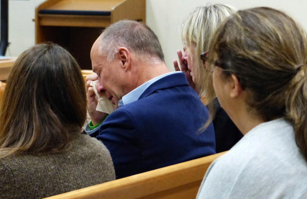 Mark Barden wipes away tears after his testimony during the Alex Jones Sandy Hook defamation damages trial at Connecticut Superior Court in Waterbury, Conn.,