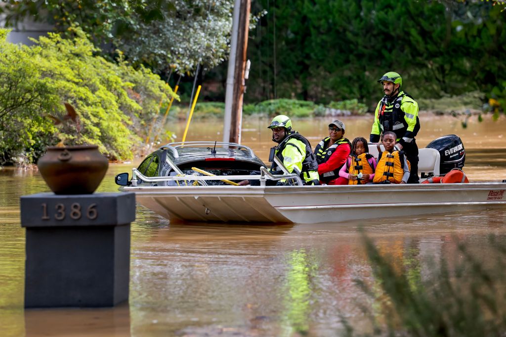 Members of the Atlanta Fire Rescue Department's Swift Water Rescue Team rescuing the Hall family from flood waters after Tropical Storm Helene in Atlanta, Georgia, USA