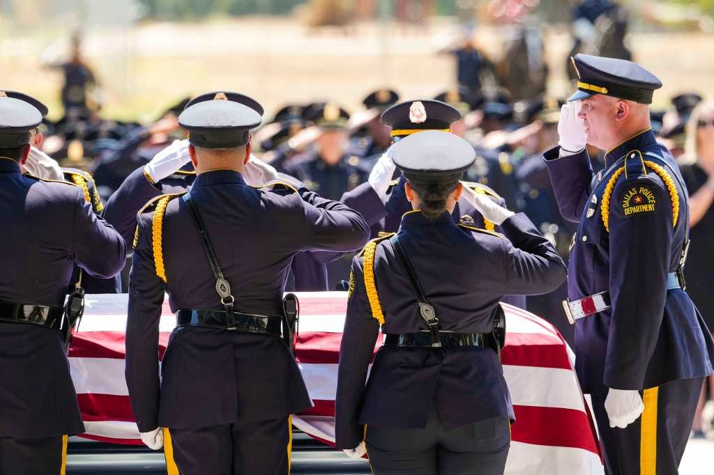 Members of the Dallas Police Honor Guard salute the casket of officer Darron Burks during his funeral at Watermark Community Church on Sept. 7, 2024.