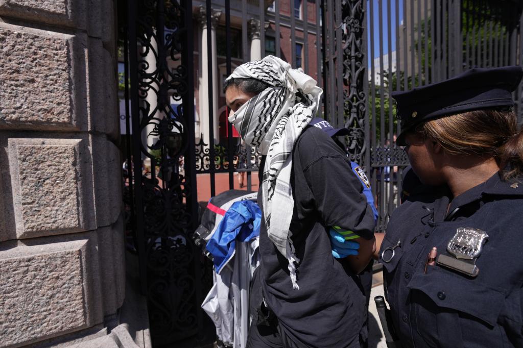 Members of the New York City Police Department arresting a pro-Palestine protestor during a demonstration outside Barnard College of Columbia University