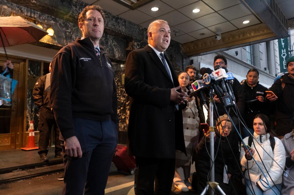 Zach Iscol, Commissioner of Emergency Management, and Manuel Castro, Commissioner of Immigrant Affairs (MOIA) standing in front of microphones