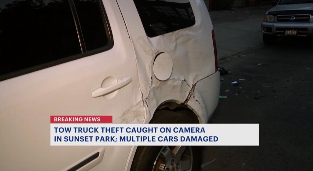 Image of a white vehicle with dents. 