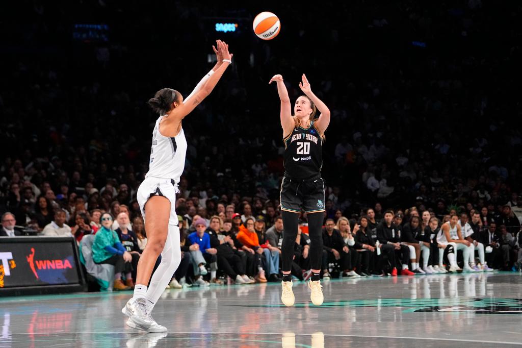 New York Liberty guard Sabrina Ionescu (20) shoots a three point jump shot over Las Vegas Aces center A'ja Wilson (22) during game one of the 2024 WNBA Semi-finals at Barclays Center. 