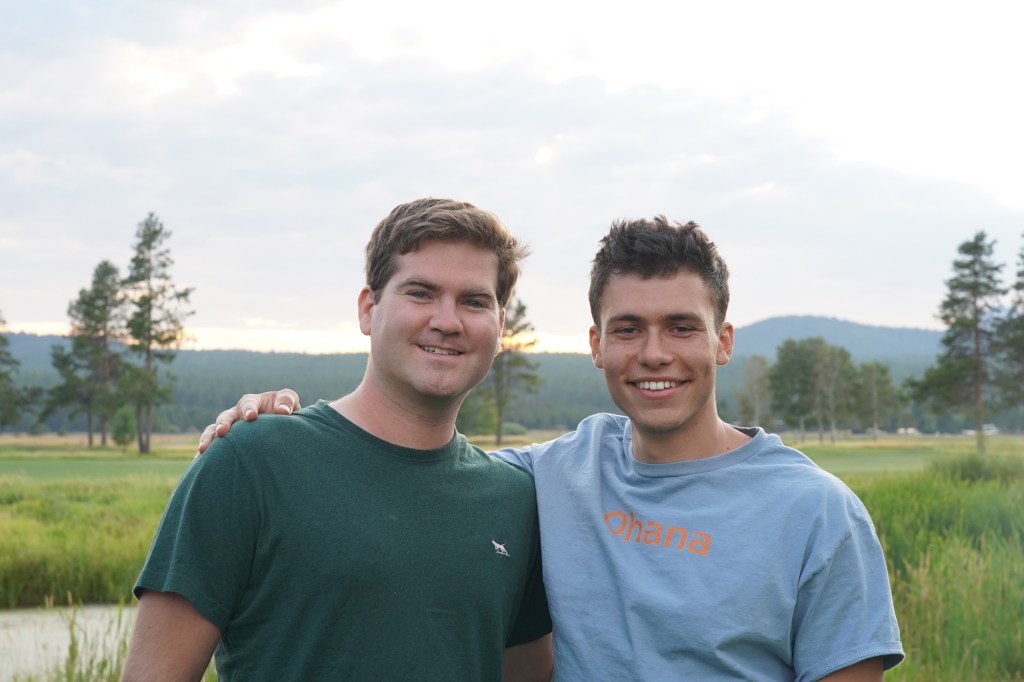 Co-founders of Ohana, Jacob Halbert and Ezra Gershanok, standing together and smiling