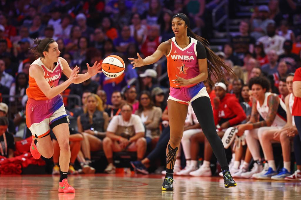 Team WNBA forward Angel Reese (5) passes the ball to Team WNBA guard Caitlin Clark (22) during the first half against the USA Women's National Team during the WNBA All-Star game at Footprint Center on July 20, 2024. 