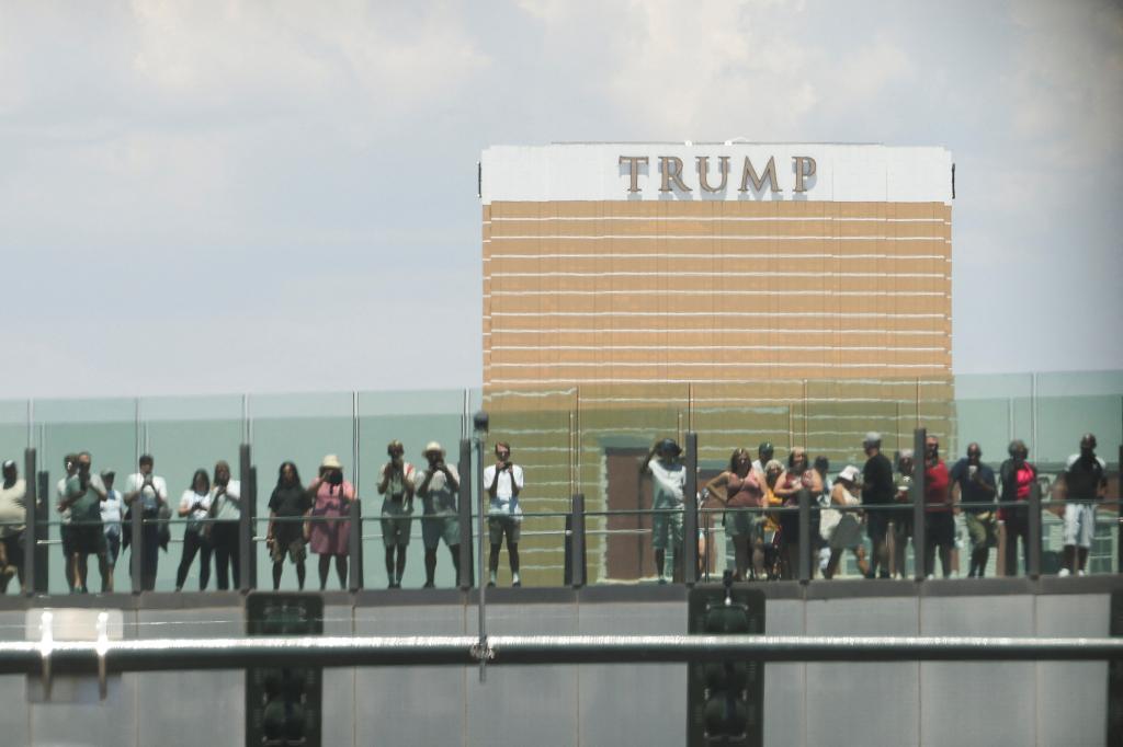 People watching President Joe Biden's motorcade pass near Trump International Hotel in Las Vegas, Nevada