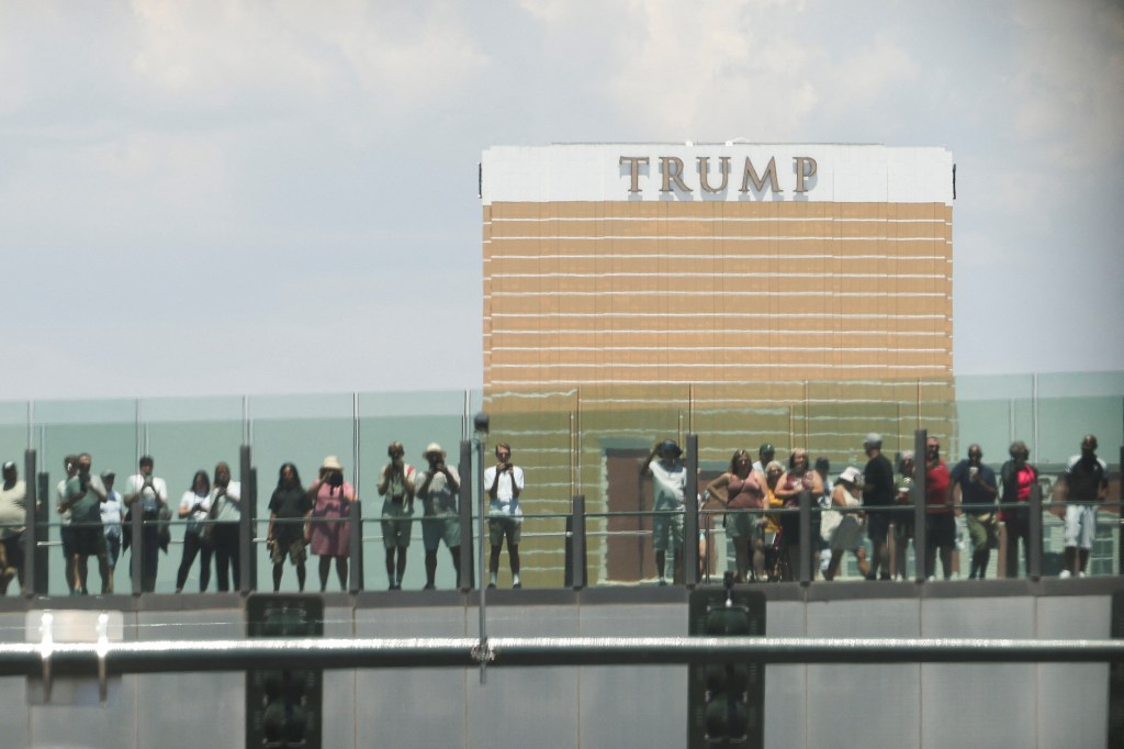 People watching President Joe Biden's motorcade pass near Trump International Hotel in Las Vegas, Nevada