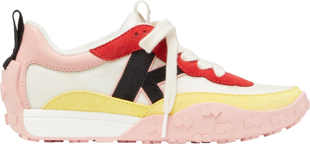 A close-up of cream and dancer pink-colored 'K As In Kate' sneakers from Kate Spade, representing the sporty academia style