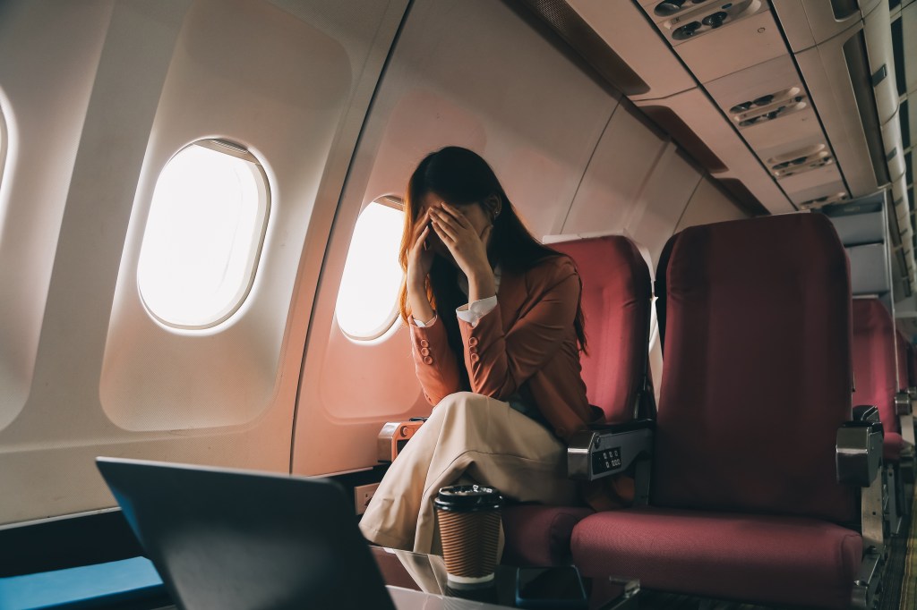 Frustrated woman on plane.