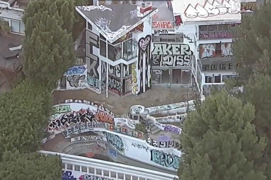 Squatters have taken over an abandoned Los Angeles mansion belonging to the son of the Philadelphia Phillies owner as neighbors view the high-end property as an eyesore and are scared for their safety.