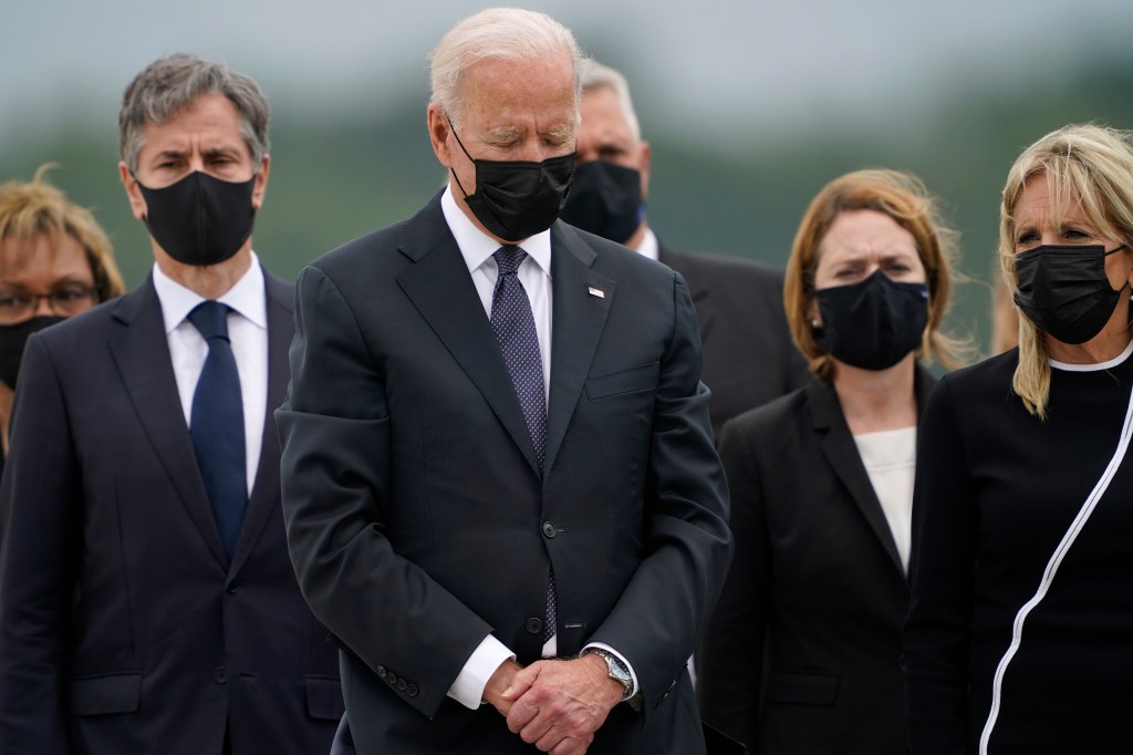 President Biden is seen second from left alongside Secretary of State Antony Blinken (far left) and First Lady Jill Biden (far right) at the dignified transfer ceremony at Dover Air Force Base on Aug. 29, 2021.