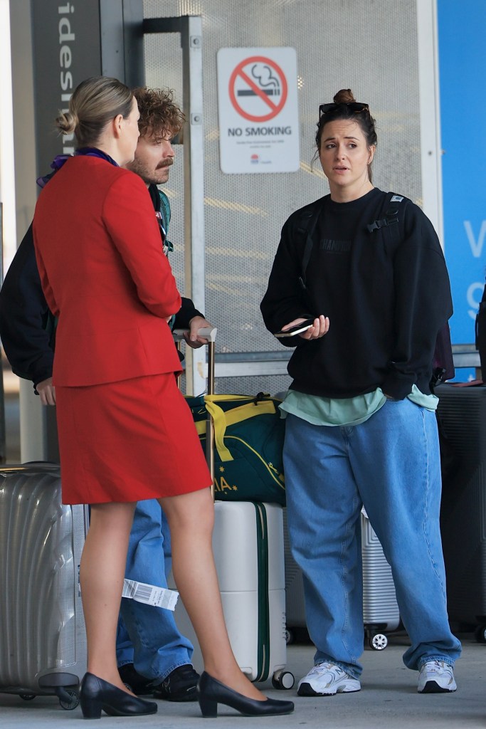 Renowned Australian Olympian Rachael 'Raygun' Gunn and her husband Samuel Free arriving at Sydney International Airport with their luggage and Team Australia sports bag