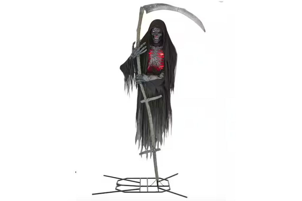 La Parka, dressed as a reaper, holding a scythe