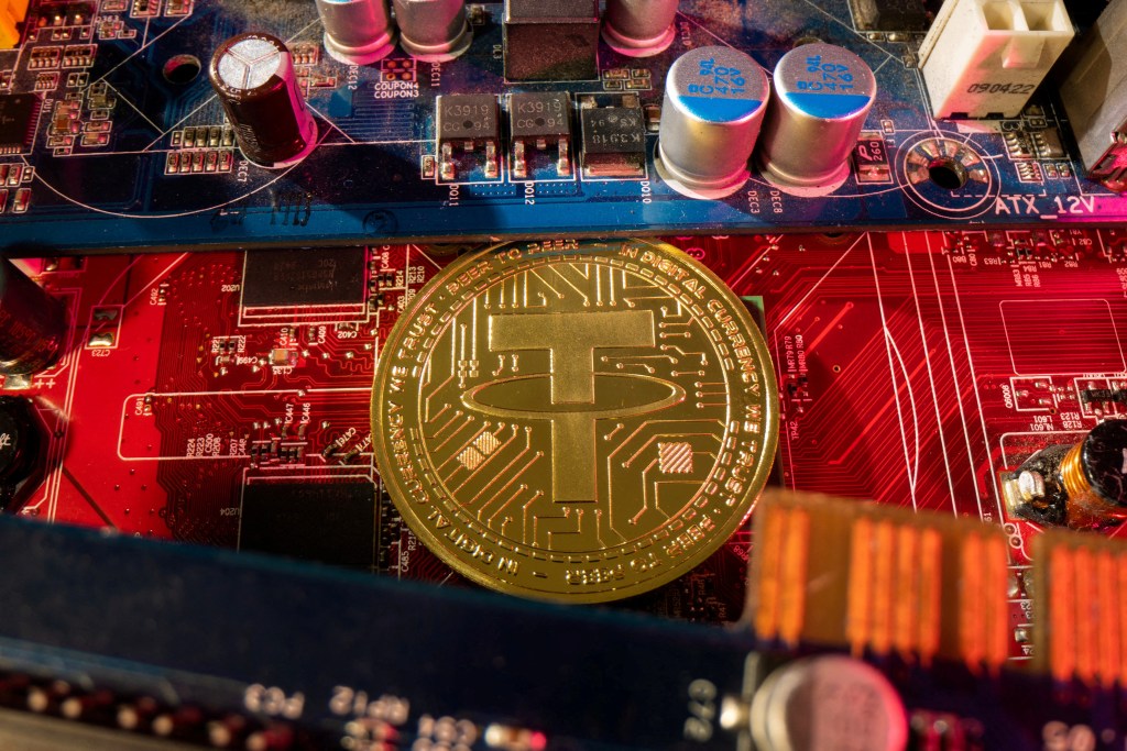 A representation of cryptocurrency Tether placed on a PC motherboard.