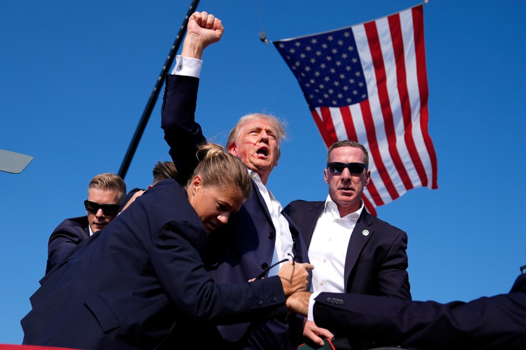 Republican presidential candidate former President Donald Trump is surrounded by U.S. Secret Service agents at a campaign rally, July 13, 2024, in Butler, Pa.