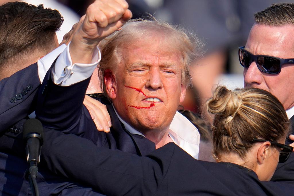 Former President Donald Trump reacting with a fist after an assassination attempt at a campaign event in Butler, Pa., July 13, 2024.