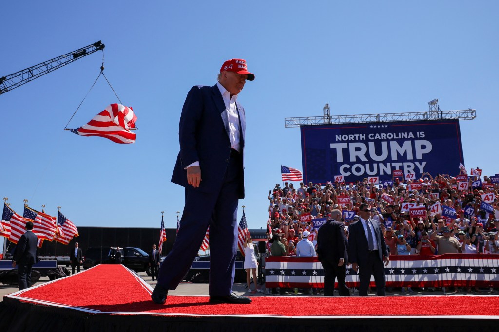 Republican presidential nominee and former U.S. President Donald Trump takes the stage at a campaign rally in Wilmington, North Carolina, U.S., September 21, 2024.