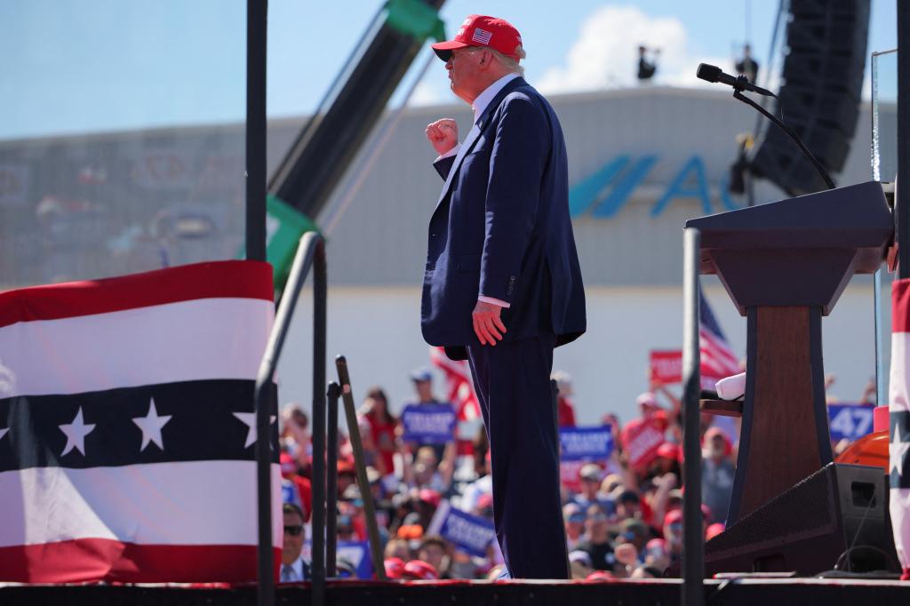 Republican presidential nominee and former U.S. President Donald Trump gestures for supporters at a campaign rally in Wilmington, North Carolina, U.S., September 21, 2024.