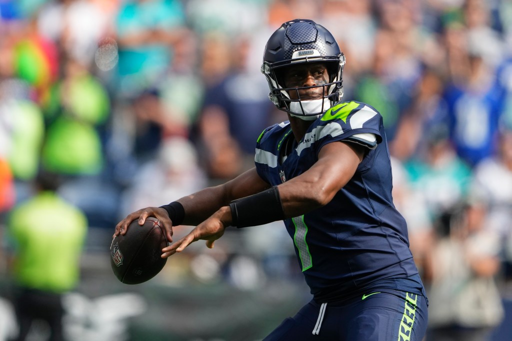 Seahawks quarterback Geno Smith looks to throw during the first half of an NFL football game against the Miami Dolphins