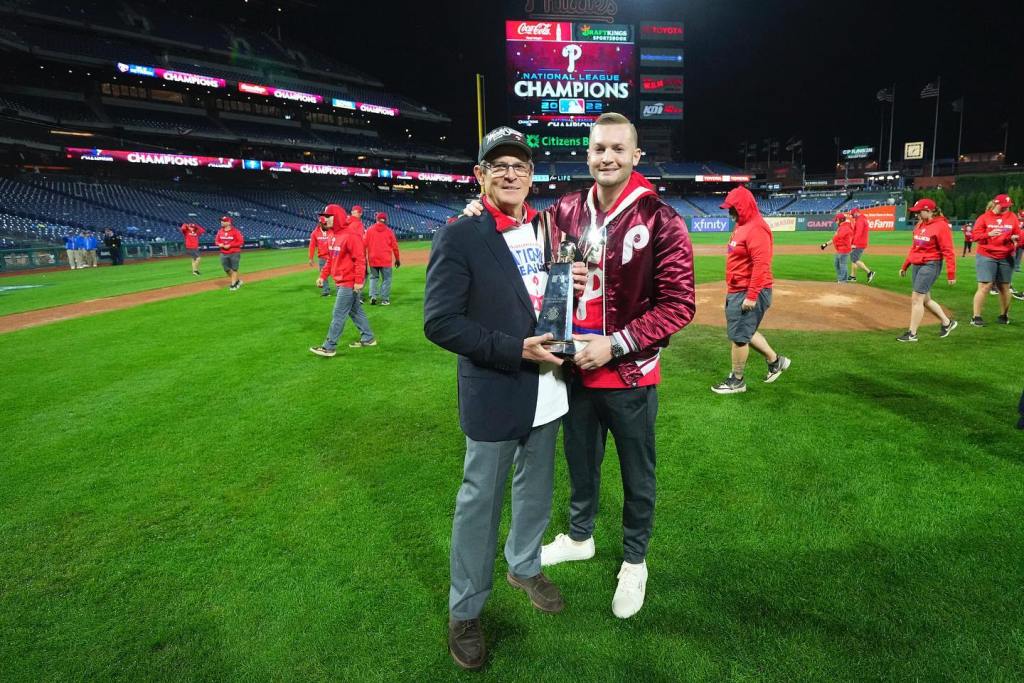 John Powers Middleton poses with his father John S. Middleton after the Phillies won the NLCS in 2022.