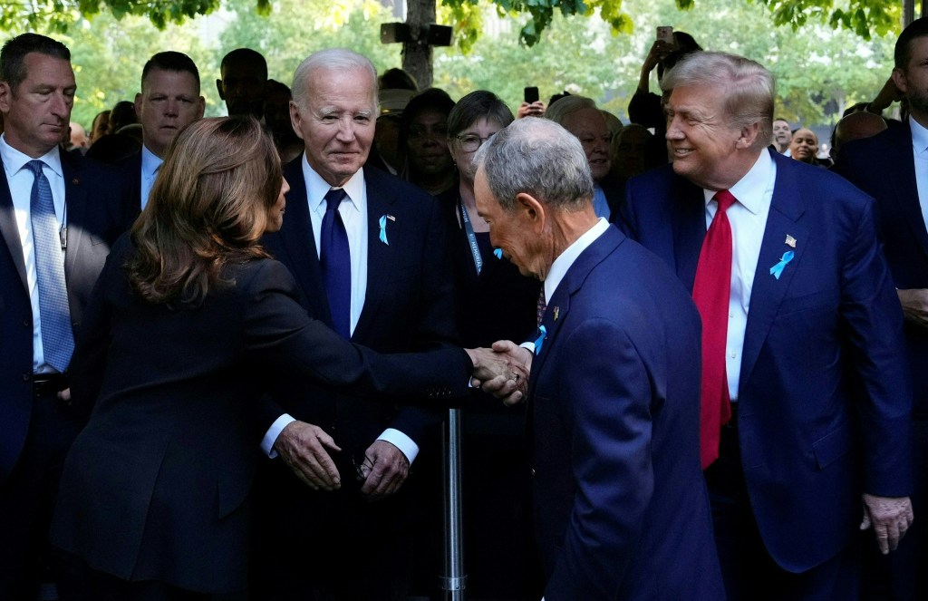 US Vice President Kamala Harris shaking hands with former US President Donald Trump at a 9/11 remembrance ceremony, with Michael Bloomberg and President Joe Biden observing