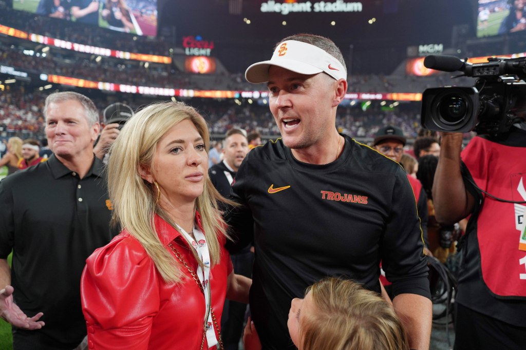 Trojans head coach Lincoln Riley with wife Caitlin Riley after the game against the LSU.