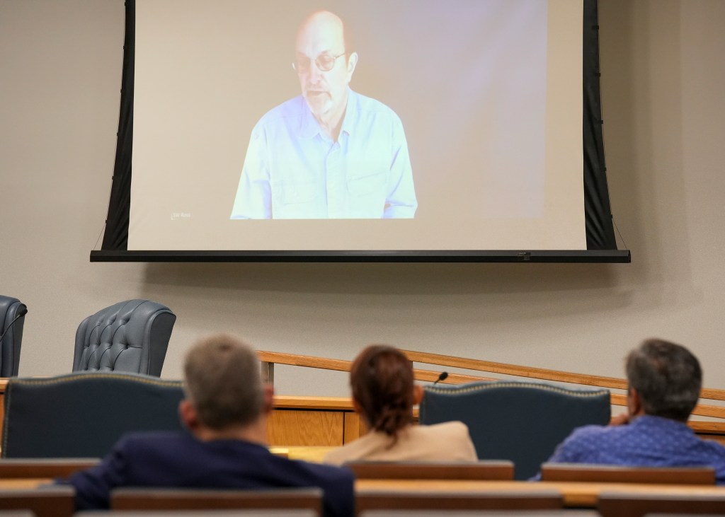 Steven Ross, former OceanGate scientific director, top, speaks via video link as he testifies during the Titan marine board formal hearing.