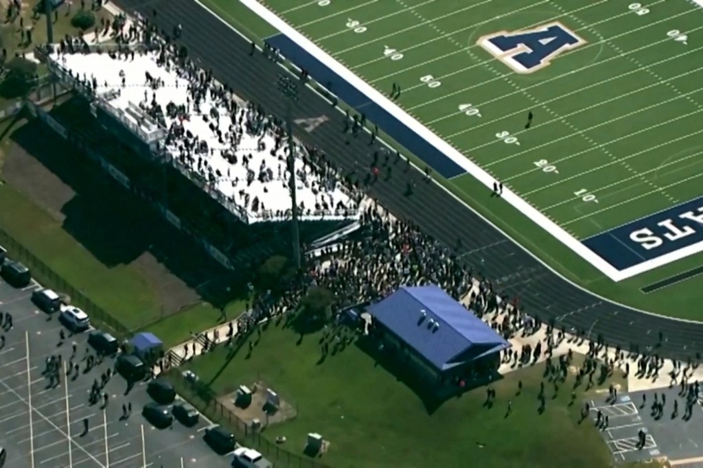 Students and staff gathered at the football field of Apalachee High School after a mass shooting on Sept. 4, 2024.