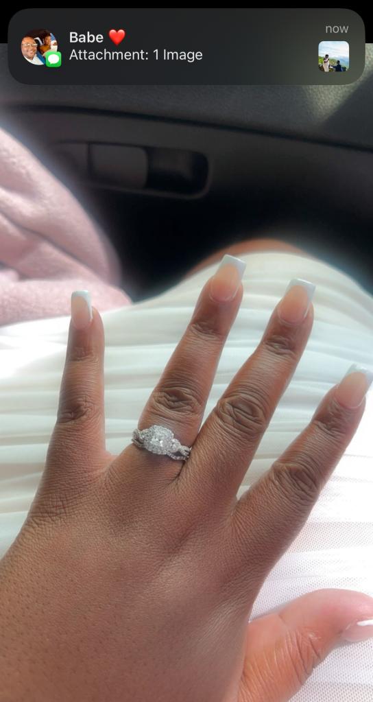 Kayla Pressley showing off her princess-cut diamond white gold engagement ring.