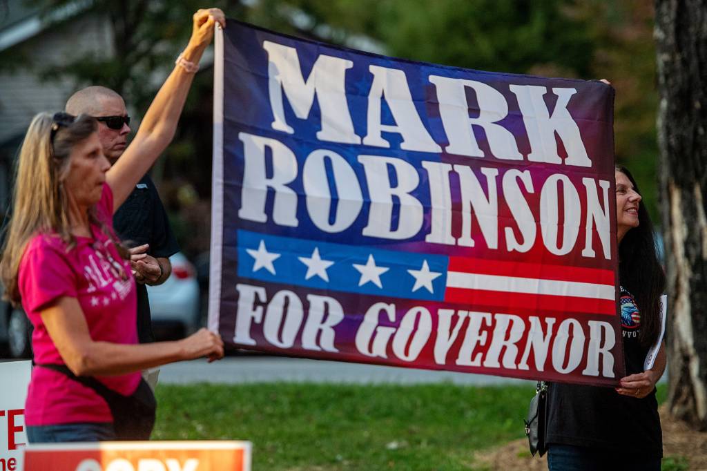 Supporters holding a sign at Mark Robinson's rally in Burnsville, September 14, 2024