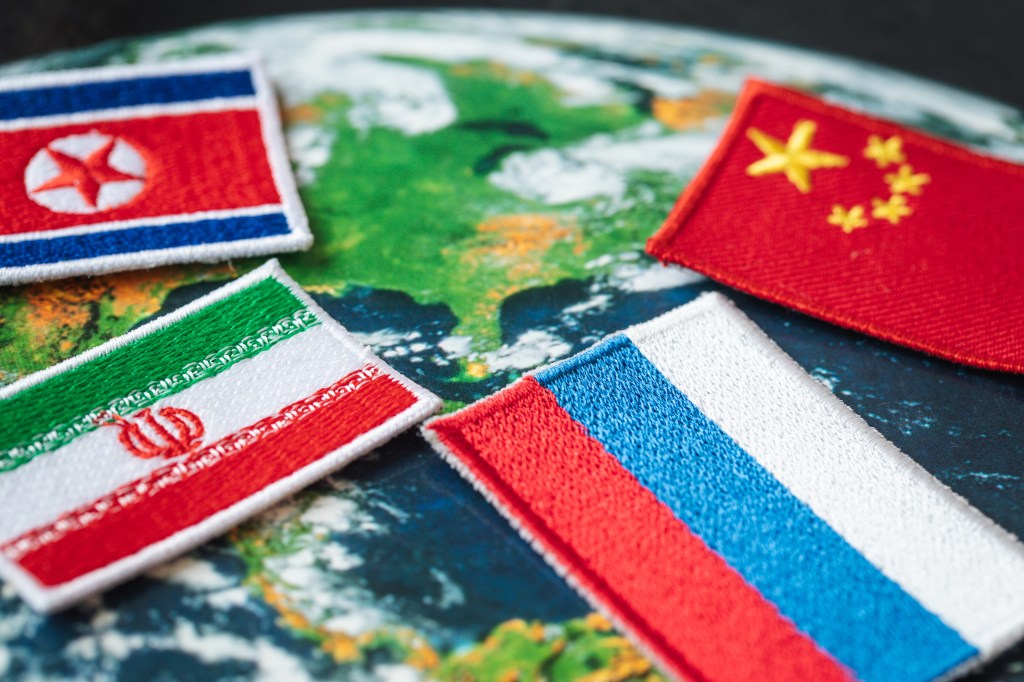 Symbols of Russia, China, North Korea and Iran against the background of the world, the concept of alliance and cooperation between countries