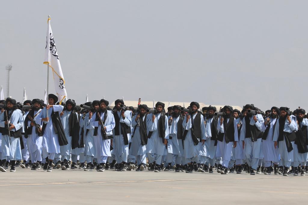 Taliban fighters march during a military parade to mark the third anniversary of the withdrawal of U.S.-led troops from Afghanistan, in Bagram Air Base in the Parwan Province of Afghanistan, Wednesday, Aug. 14, 2024.