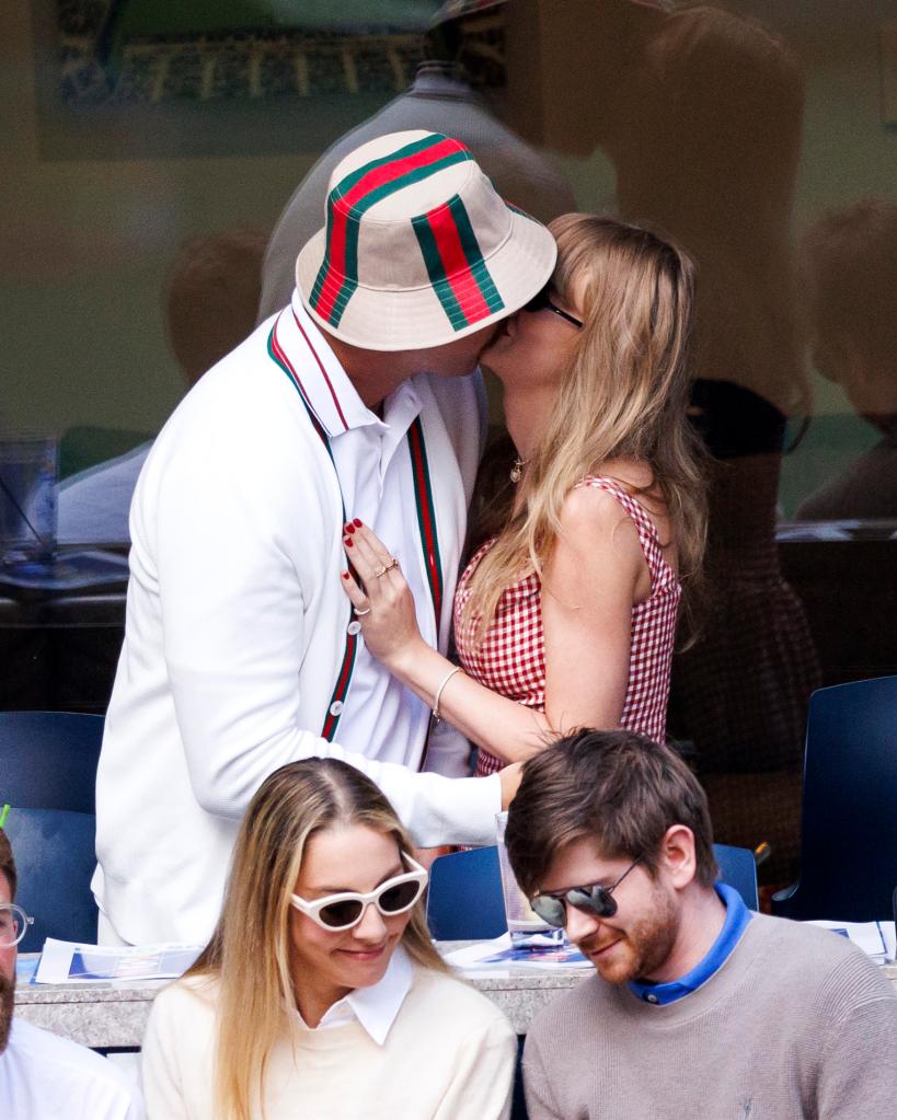 Travis Kelce and Taylor Swift kiss during the U.S. Open on Sept. 8, 2024.