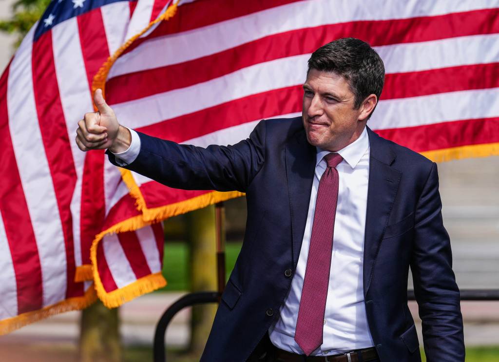 U.S. Representative Bryan Steil giving a thumbs up while taking the stage at a press conference on crime and safety in Kenosha, Wisconsin