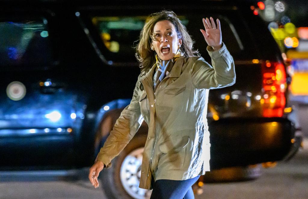 Harris waves as she walks to a vehicle after landing at San Francisco Airport on Sept. 27, 2024.