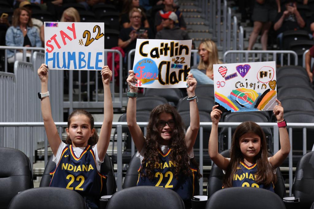 Three little girls in Caitlin Clark jerseys.