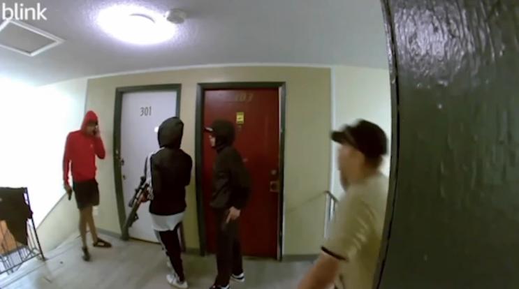 A group of armed men, part of the Venezuelan transnational gang Tren de Aragua, flaunting guns inside a Colorado apartment building hallway