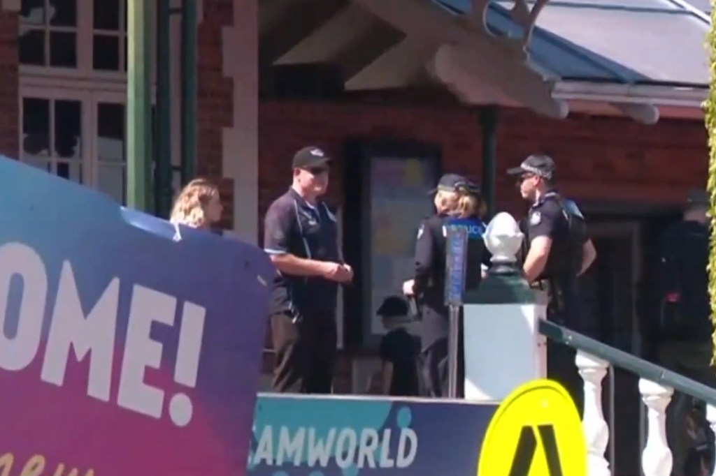 Four police officers talk at Dreamworld theme park