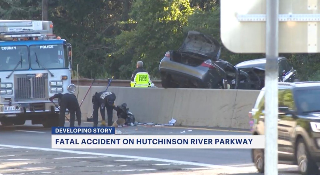 Emergency response at the scene of a wrong-way crash on the Hutchinson River Parkway in Westchester, New York, with a car engulfed in flames.