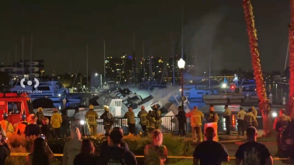 The destroyed yacht sank into the water around 10:30 p.m. while the fire continued to burn below deck.