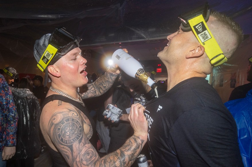 Alex Verdugo and Clarke Schmidt celebrate in the clubhouse on Sept. 26.