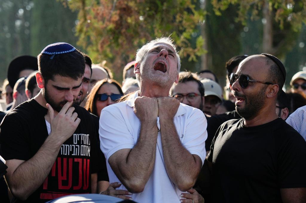 Yigal Sarusi yells in tears as he buries his son, Almog Sarusi. 