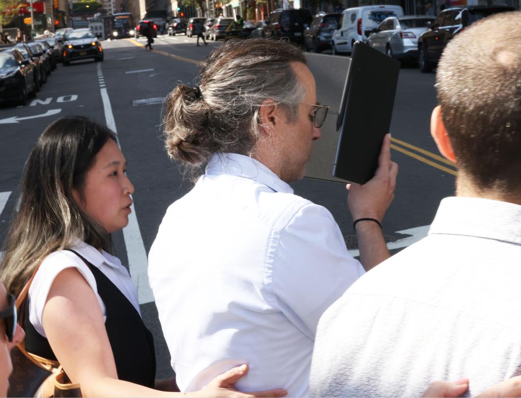 Zachariah Reed tried to duck a photographer as he leaves court on Thursday, with his lawyer, Nicky Rooz.