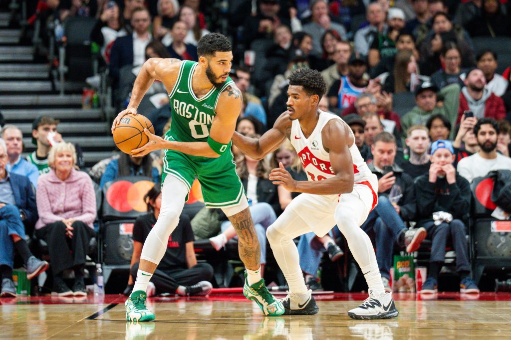 Celtics forward Jayson Tatum (0) guards the ball against Toronto Raptors guard Ochai Agbaji 